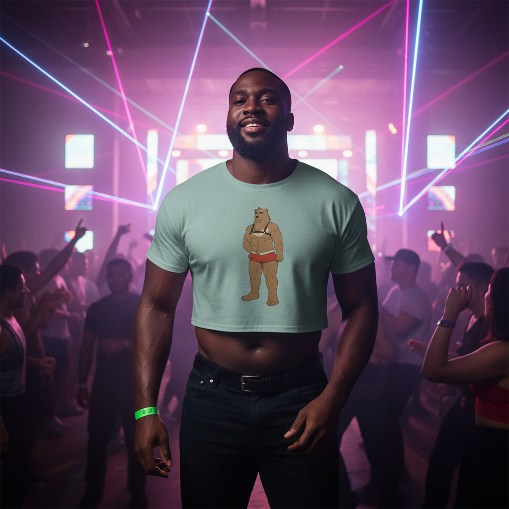 Gay Bear Crop Top featuring a cartoon bear print, worn with dark jeans and a green wristband at a vibrant Pride nightclub.