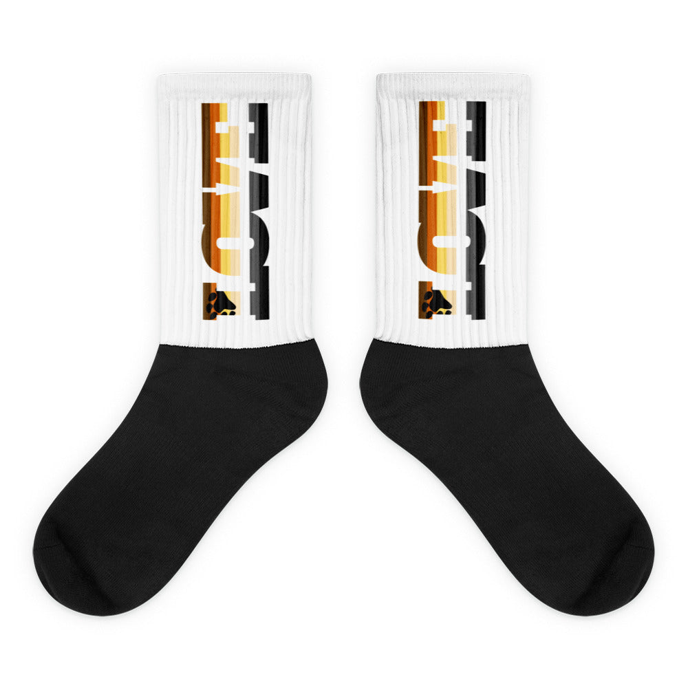Pair of black-toe socks with white ribbed cuffs and vertical multicolor graphic text