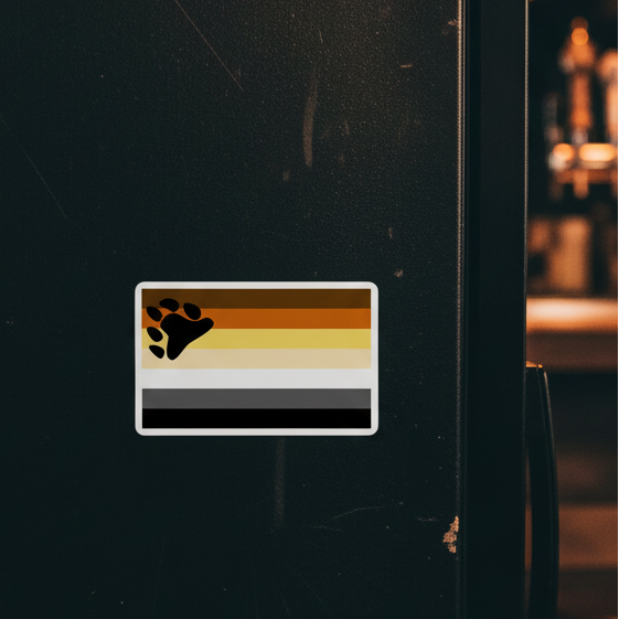 Gay Bear Pride vinyl sticker with bear flag stripes and paw print pops on a dark fridge; warm glow