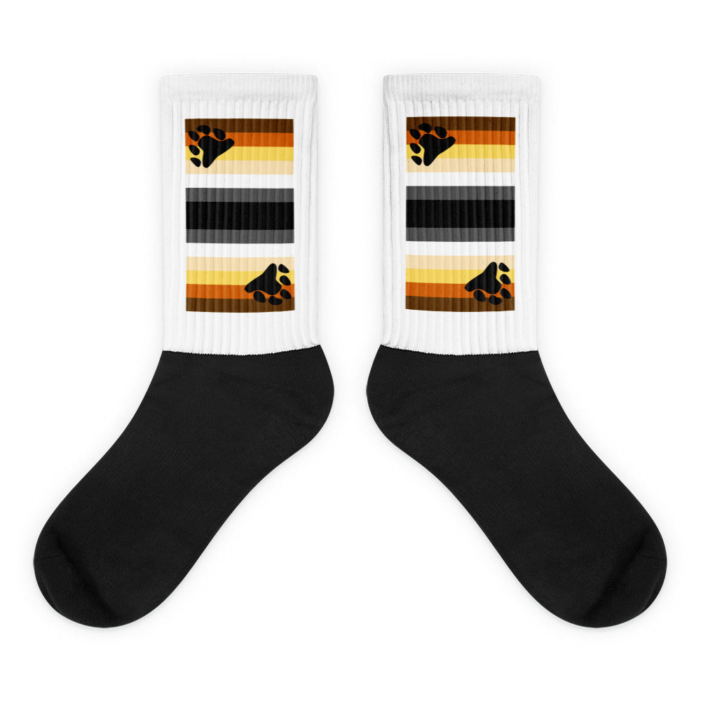 Pair of black-and-white socks with bear-paw rainbow stripes on the cuffs