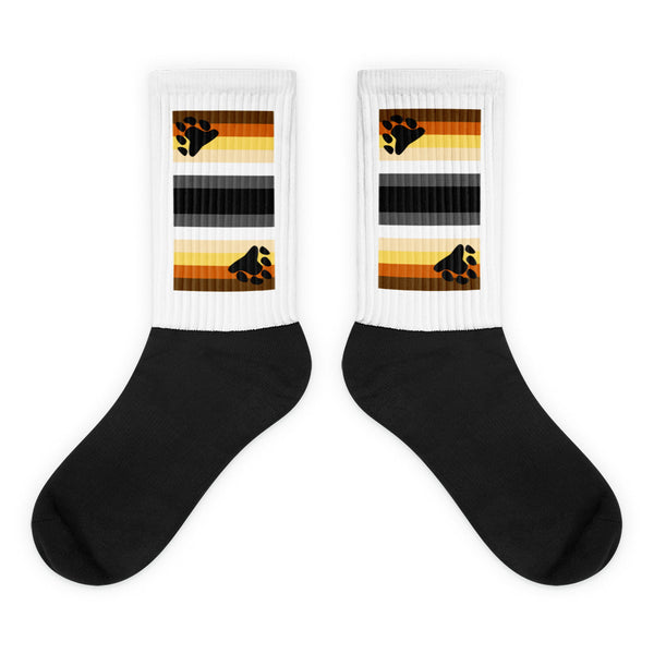 Pair of black-and-white socks with bear-paw rainbow stripes on the cuffs