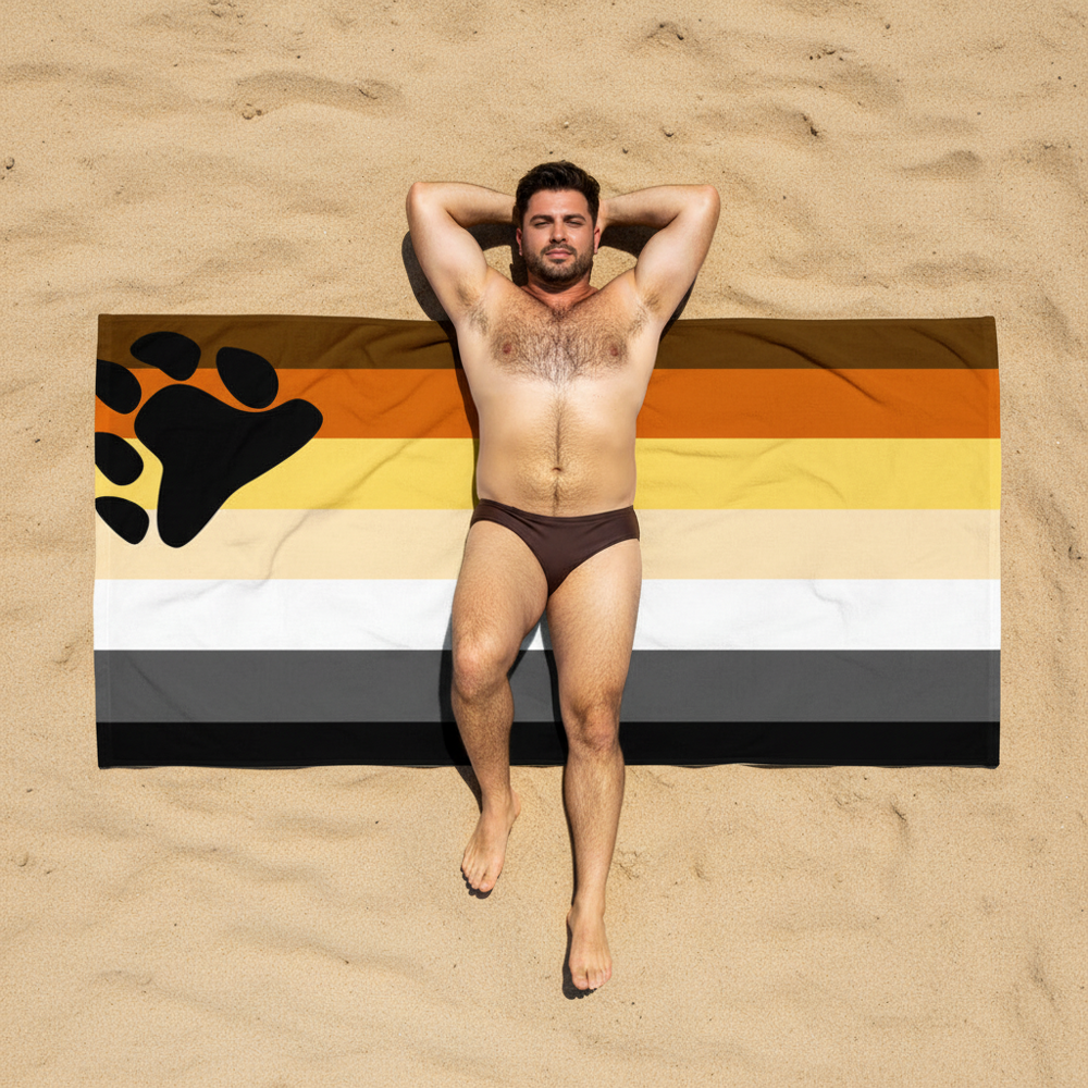 Gay Bear Pride beach towel with brown, orange, yellow, white, gray, and black stripes plus a paw print