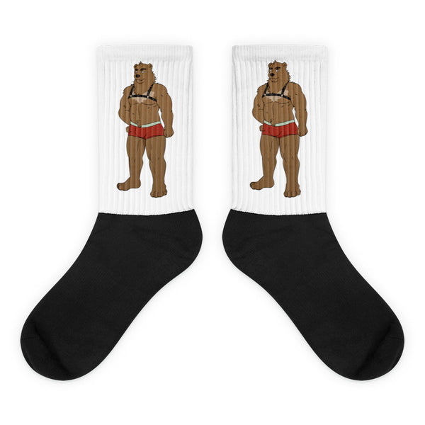 Pair of white-and-black socks with muscular bear illustrations in red briefs and black harnesses