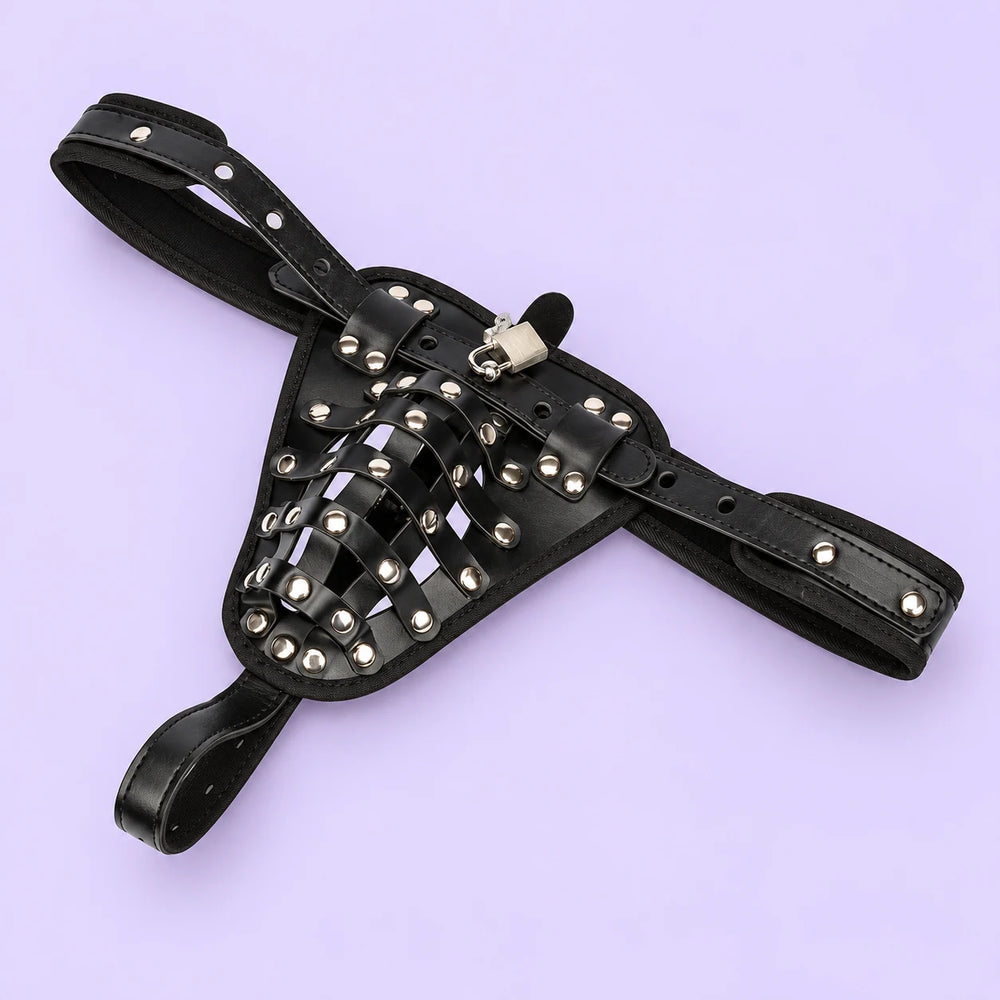 Black chastity locking belt briefs arranged diagonally on lavender, showing the waist straps, rivets, cage and padlock.