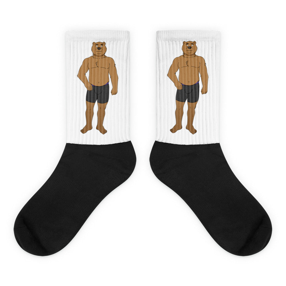 Pair of crew socks with black feet and white cuffs showing cartoon brown bears in black underwear