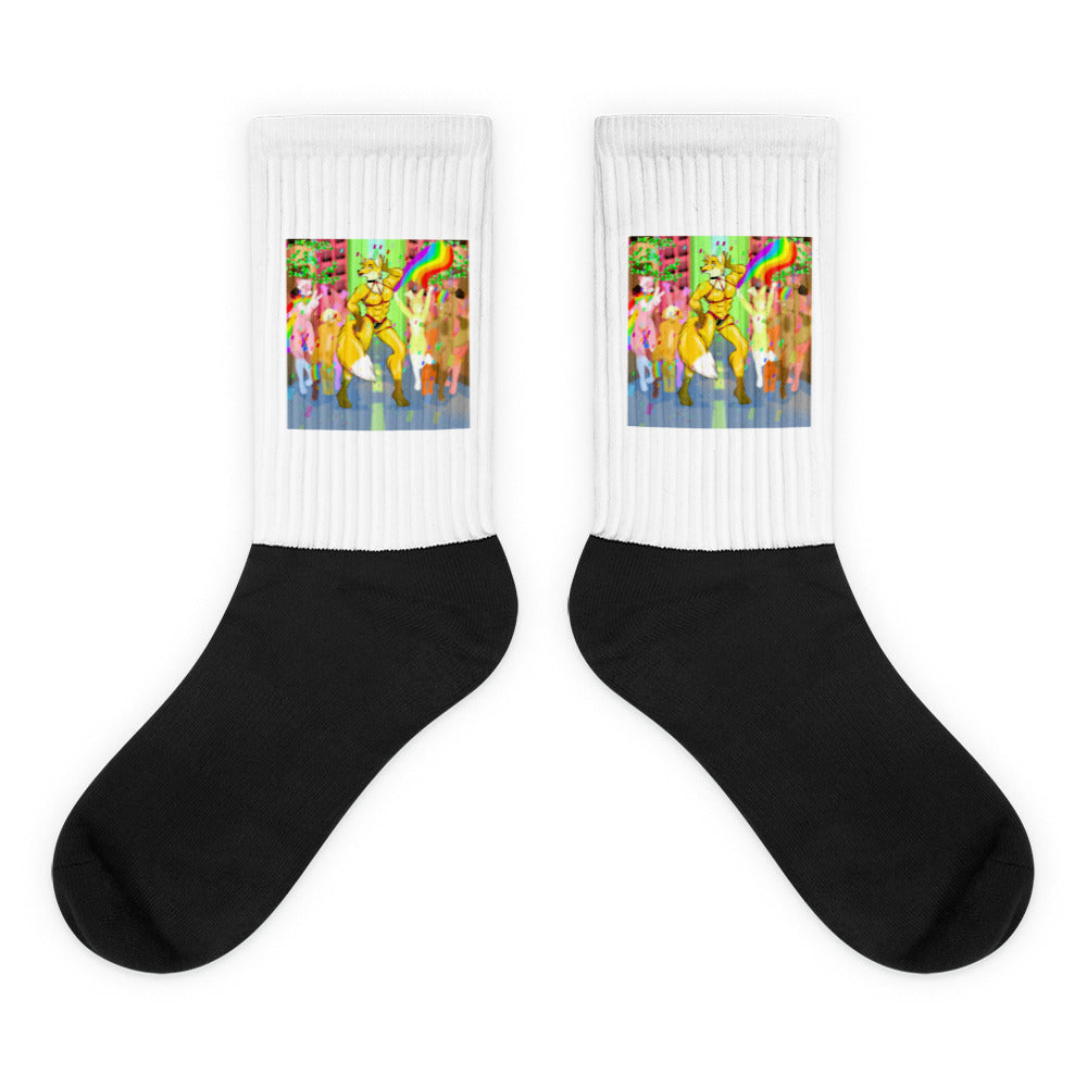 Pair of black-and-white socks with colorful furry characters dancing beneath rainbows