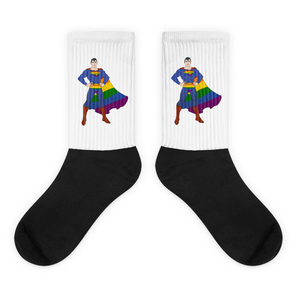 Pair of black-and-white crew socks featuring a superhero in a rainbow cape