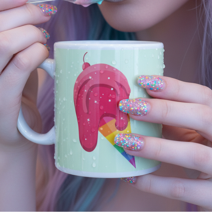 Close-up of a mint mug with a dripping pink ice cream graphic over a rainbow popsicle