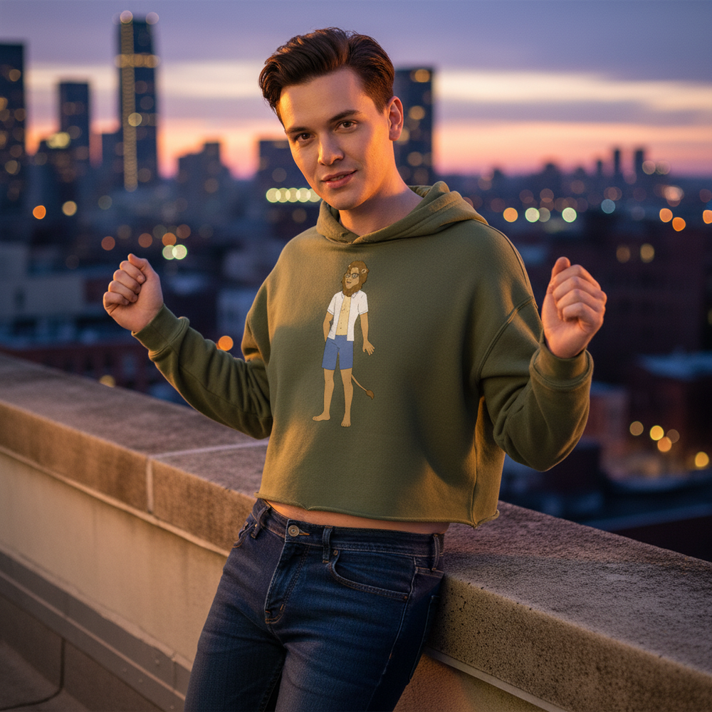 Olive green Gay Nerd Crop Hoodie with a cartoon person, fists raised, worn by a person posing on a sunset-lit rooftop