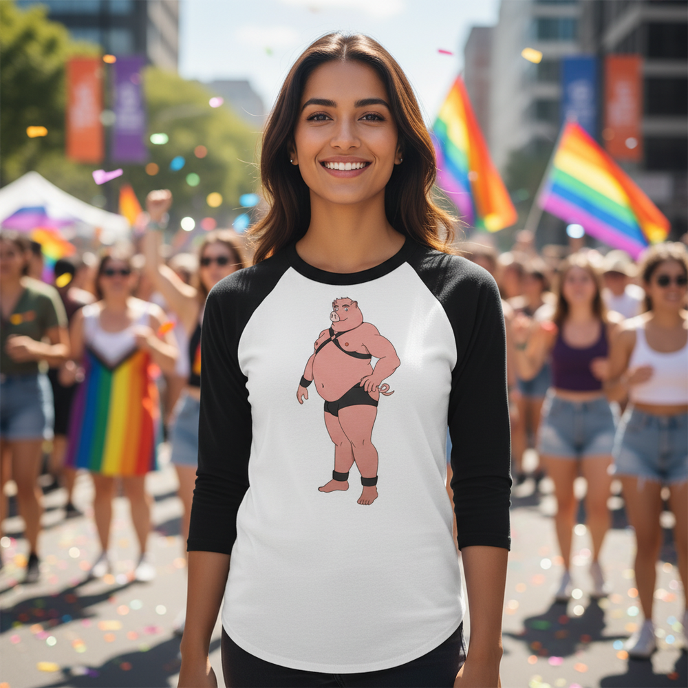 Gay Pig 3/4 Sleeve Raglan Shirt with a cartoon wrestler, worn by a smiling person at Pride amid rainbow flags, sun