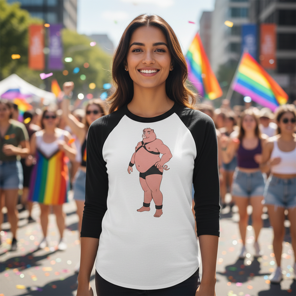 Gay Pig 3/4 Sleeve Raglan Shirt with a cartoon wrestler, worn by a smiling person at Pride amid rainbow flags, sun