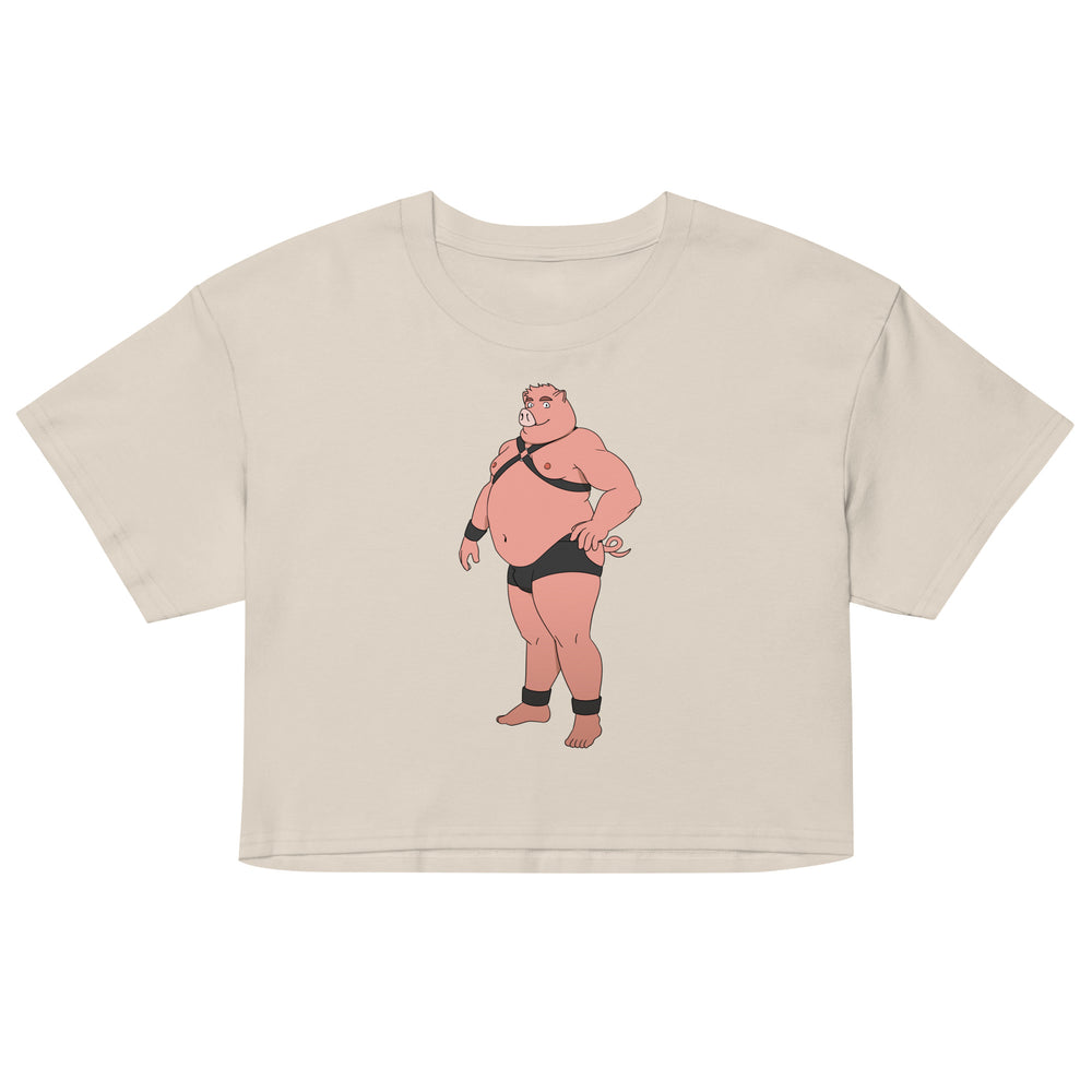 Front view of a beige crop top with a cartoon pig in black harness gear and briefs