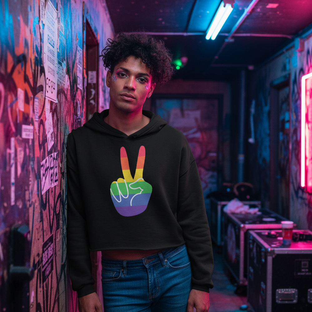 Gay Pride crop hoodie with a rainbow peace sign, worn by a person leaning