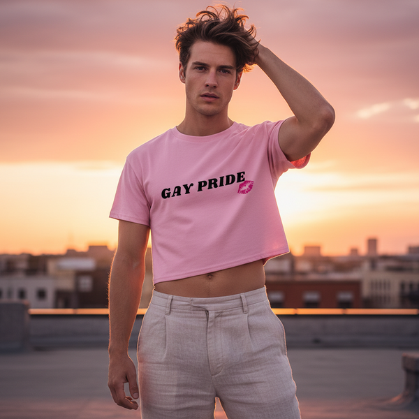 Person wearing a pink cropped T-shirt reading “GAY PRIDE” on a rooftop at sunset
