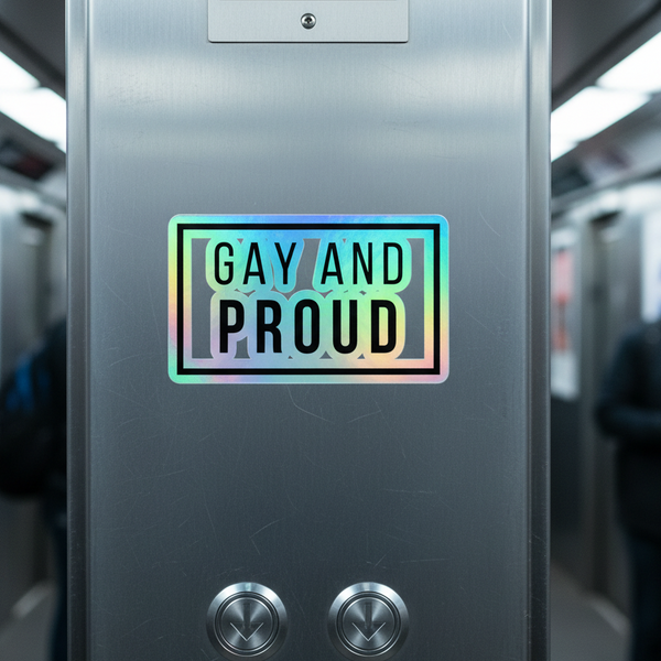 Gay And Proud Holographic Sticker with bold black text shines rainbow on a metallic subway wall above elevator buttons