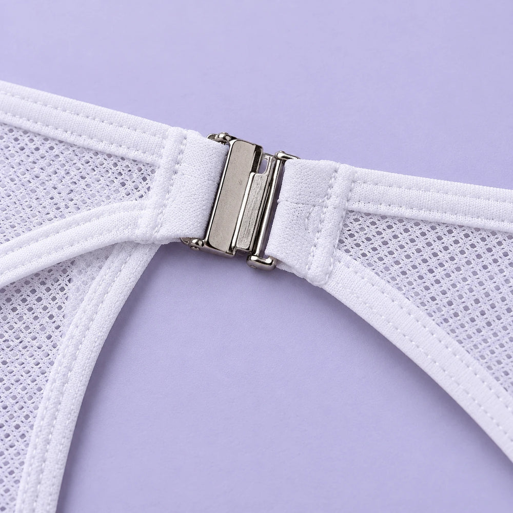 Close-up of the silver side clasp, white binding and mesh fabric on white Gay Clip Panties against lavender.