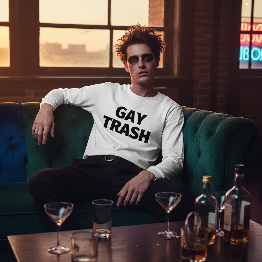 Unisex long sleeve tee with “Gay Trash” in bold black text, worn by a person on a green sofa under neon lights
