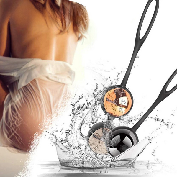 Two black vibrating kegel balls splashing in water beside a cropped model in lingerie