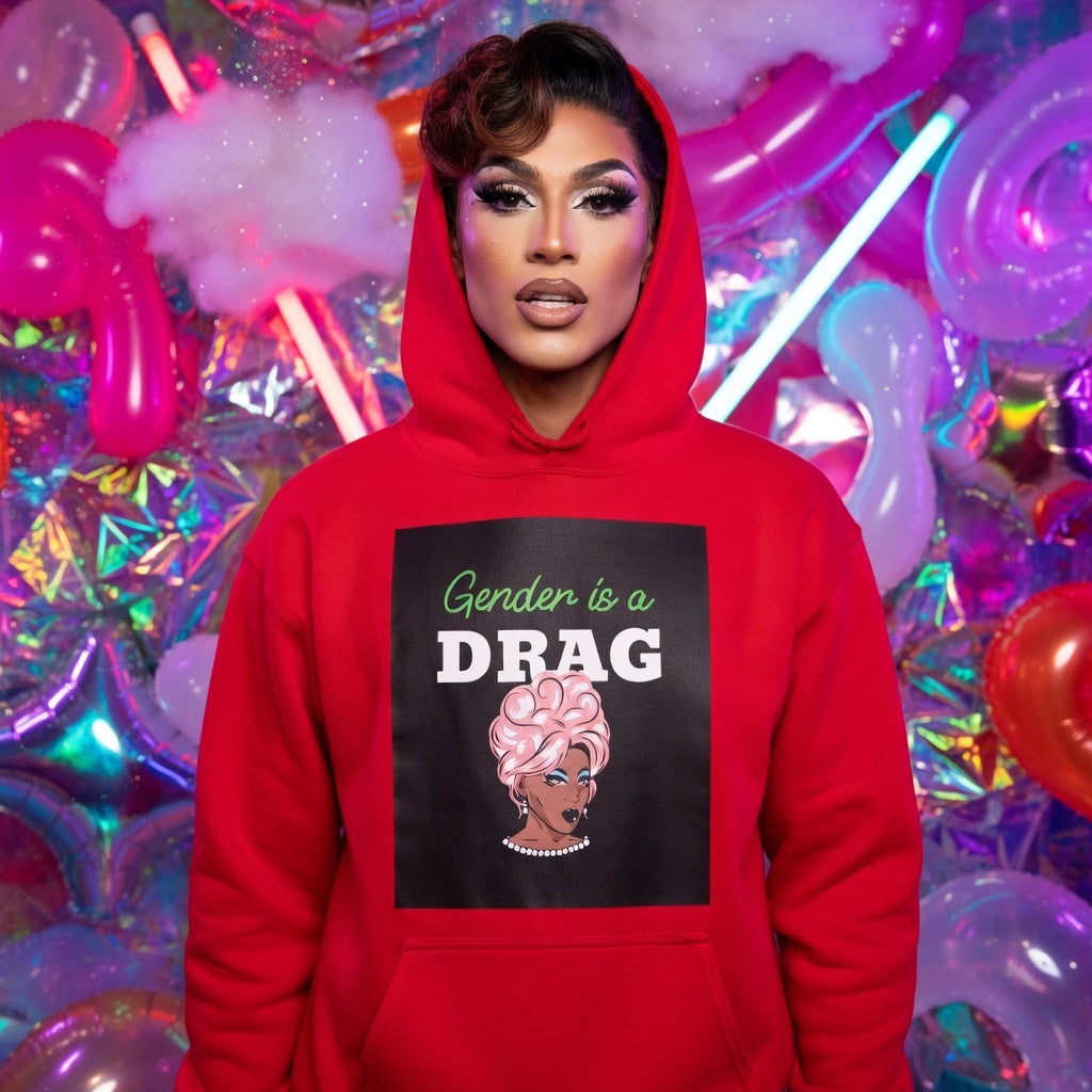 Gender Is A Drag Unisex Hoodie with bold lettering and drag queen art, modeled by a person in glam makeup amid neon, foil