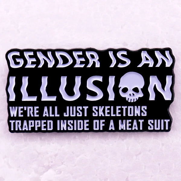 Black enamel pin reading “GENDER IS AN ILLUSION” with a skull and skeleton slogan