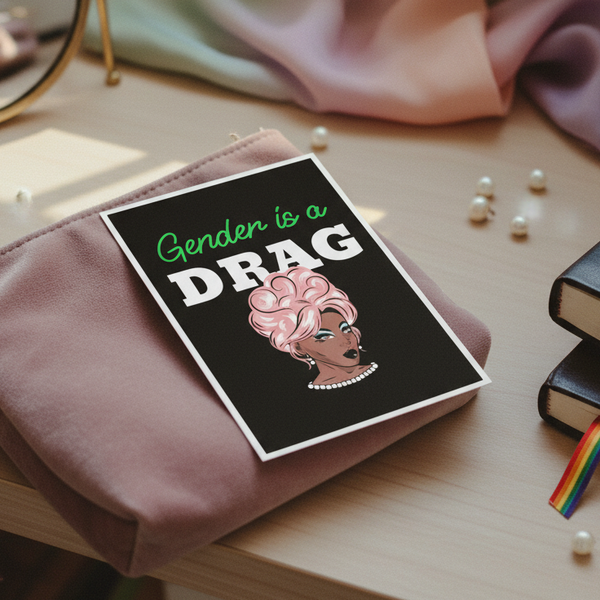 Postcard showing a drag queen with pink hair, pearls, bold makeup, and “Gender is a Drag” on pink pouch with rainbow ribbon