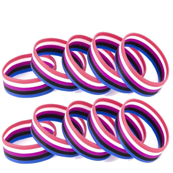 Multiple pink, white, purple, black, and blue striped rubber wristbands on white