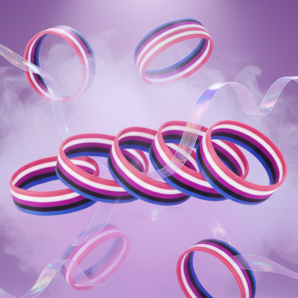 Genderfluid pride rubber wristbands floating against a lavender background with translucent ribbon