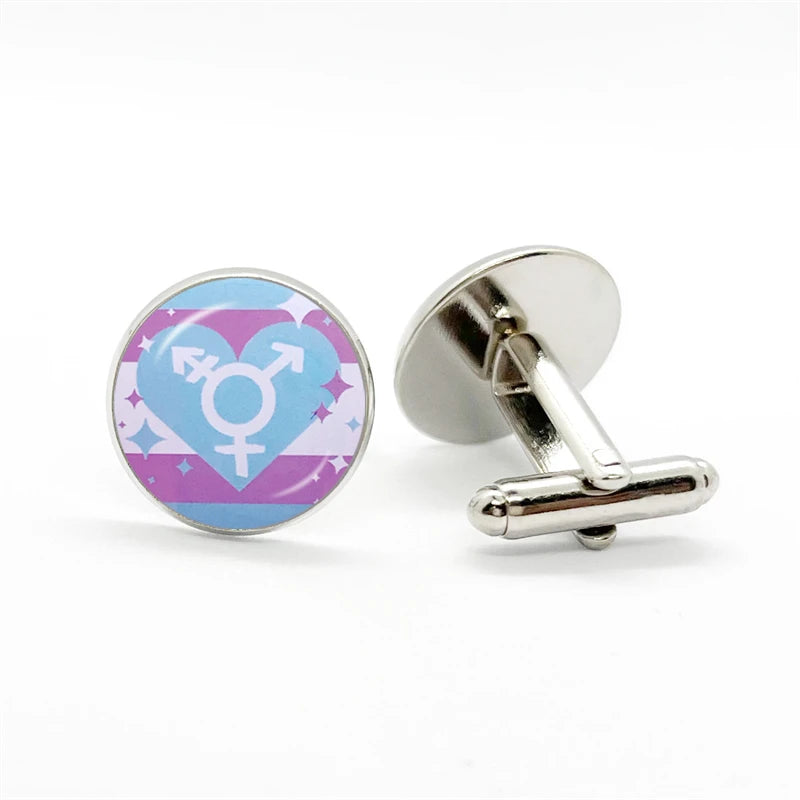 Round silver cufflinks, one showing a blue and pink gender symbol design and one showing its T-bar backing