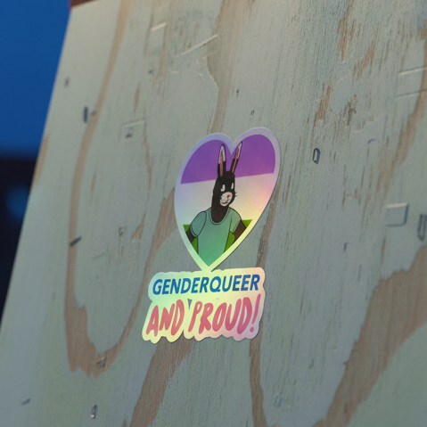 Holographic sticker with black rabbit in green shirt on pastel genderqueer flag heart
