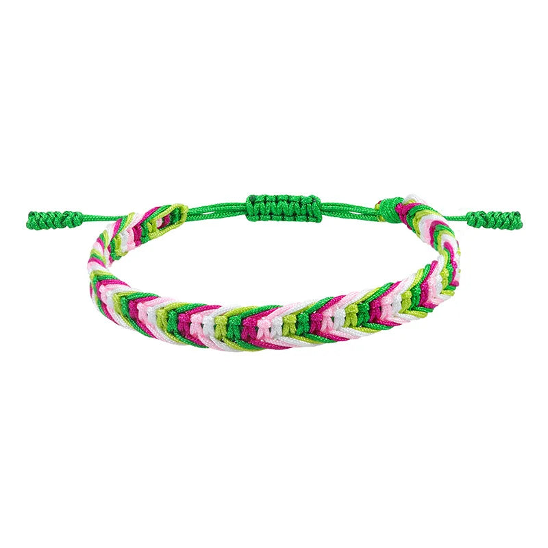 Braided green, pink, white, and lime friendship bracelet with adjustable green cord ends