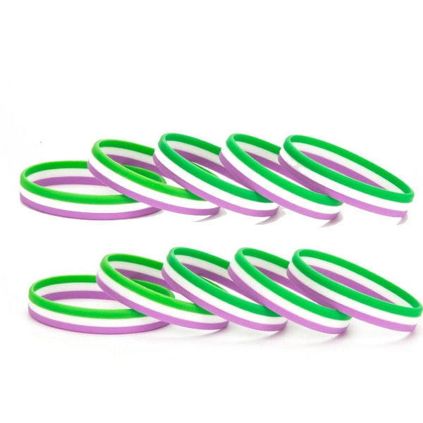 Two rows of green, white, and lavender rubber wristbands overlapping on a white background