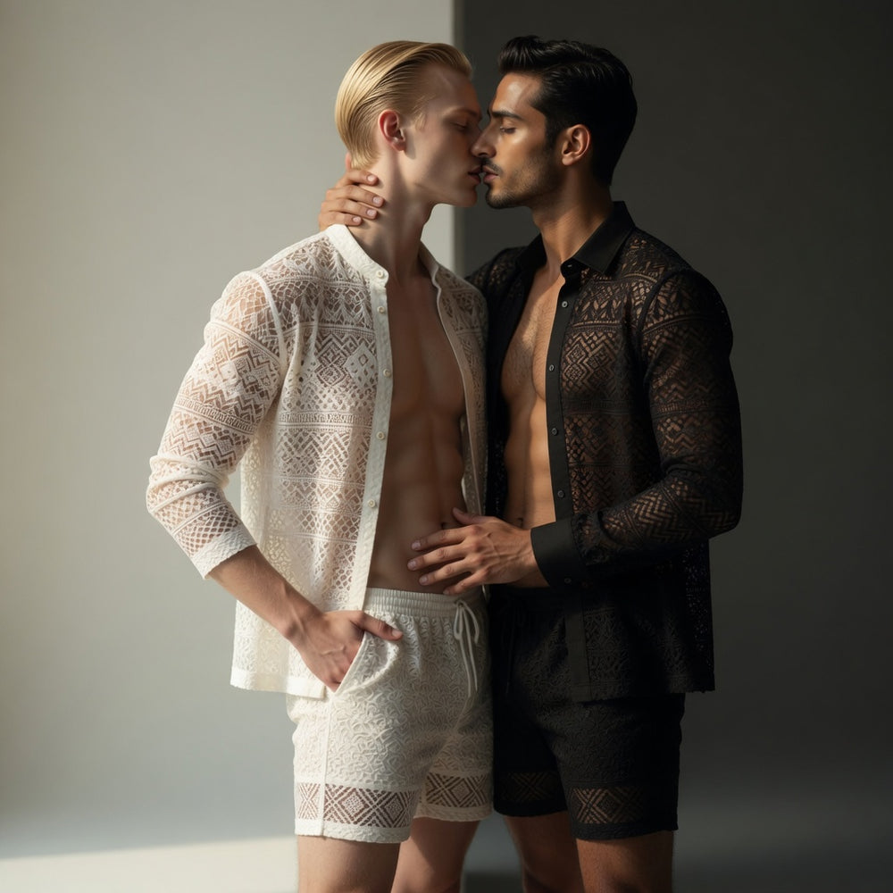 Two people kiss while modeling matching white and black geometric lace shirts and shorts