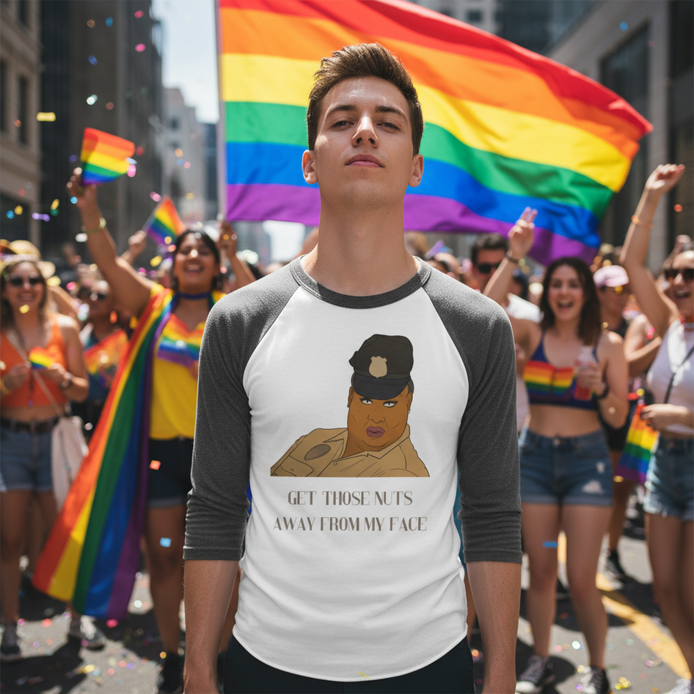 3/4 sleeve raglan shirt with “Get Those Nuts Away From My Face!” slogan, worn by a person at Pride near a big rainbow flag