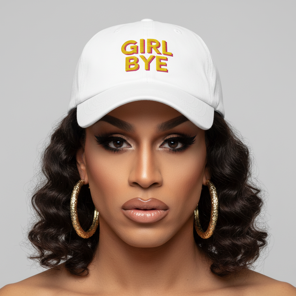 Girl Bye Cap: white hat with “GIRL BYE” in bold yellow and pink, worn by a person with wavy brown hair and gold hoops.