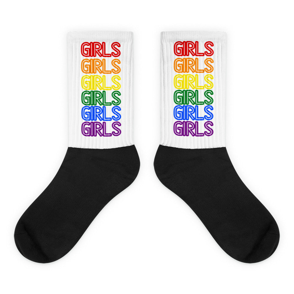 Pair of black-and-white socks with rainbow-colored GIRLS text on the cuffs