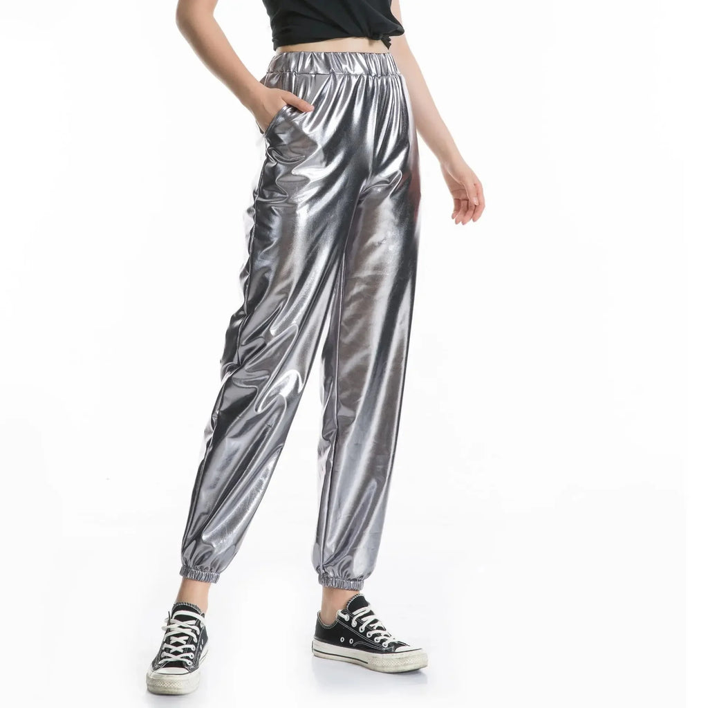 Front view of a model wearing shiny silver high-waisted jogger pants with elastic cuffs