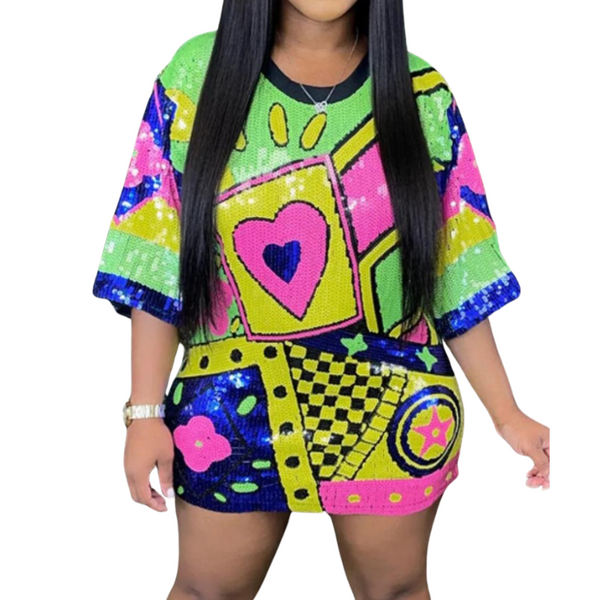 Front view of a model wearing a colorful sequin mini dress with a large heart motif