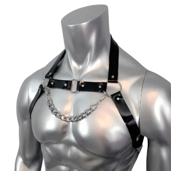 Front view of a black leather chest harness with a draped silver chain on a mannequin