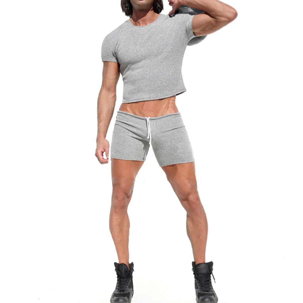 Front-view model wearing a gray cropped T-shirt and matching drawstring sweatshorts