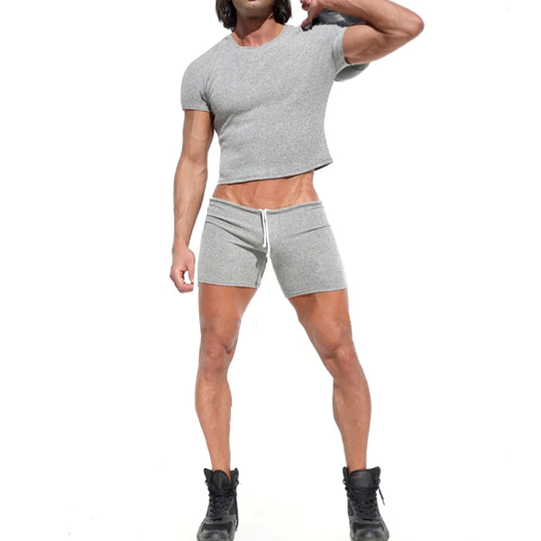 Front-view model wearing a gray cropped T-shirt and matching drawstring sweatshorts