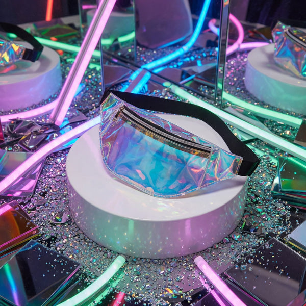 Iridescent translucent fanny pack with black zipper and adjustable strap on a neon-lit display