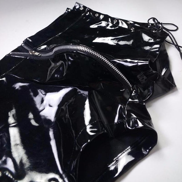 Close-up of black glossy vinyl lace-up boxers with multiple zippers