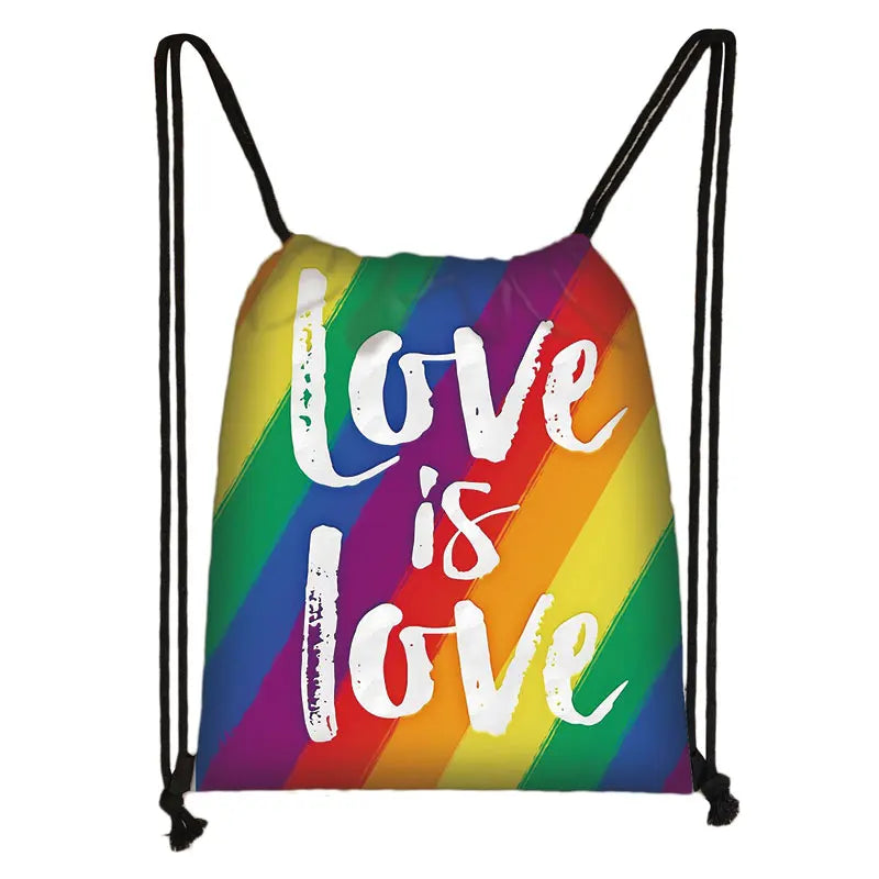 Rainbow drawstring bag with white “Love is Love” lettering and black cord straps