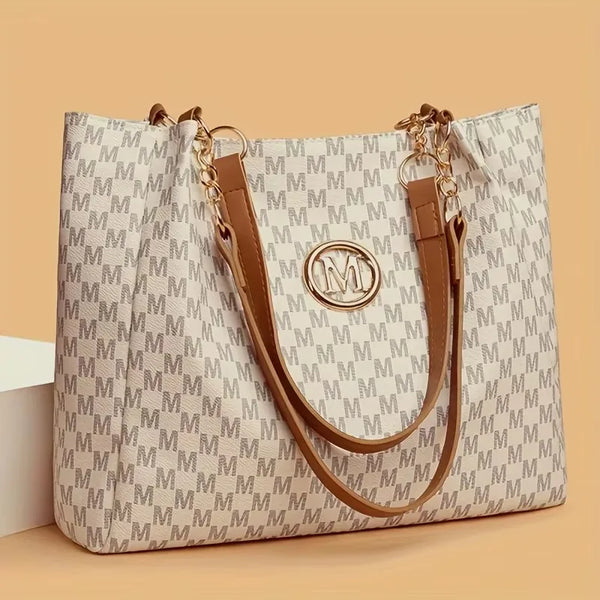 Structured off-white monogram tote with tan shoulder straps and a round gold M emblem