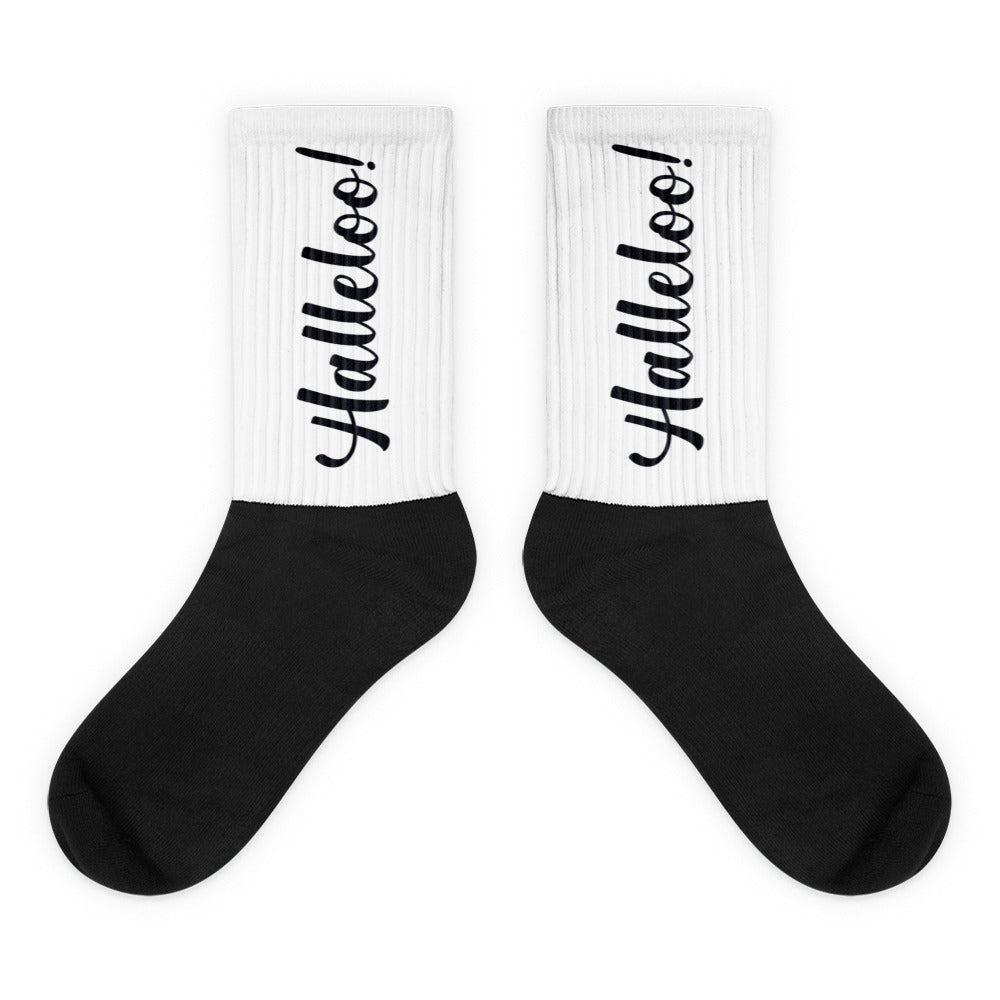 Pair of black-and-white crew socks with “Halleloo!” printed vertically on the cuffs