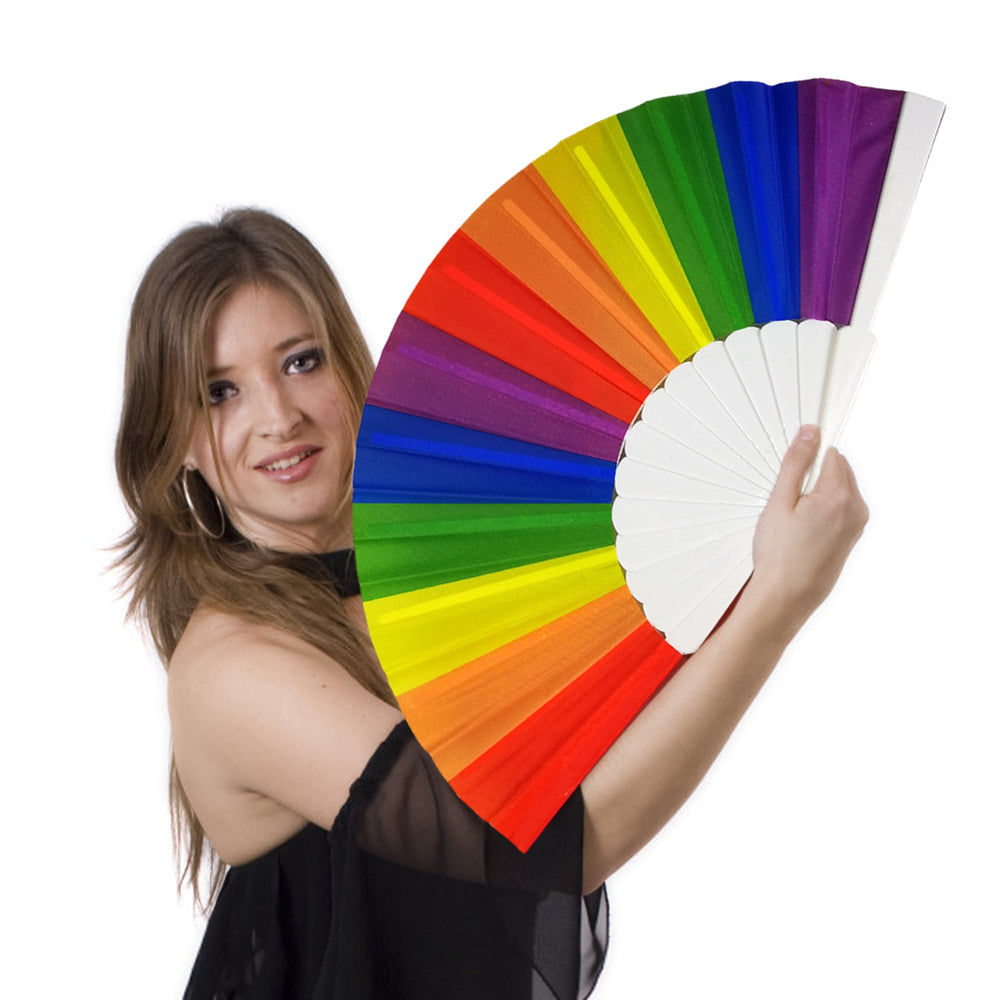 Person holding an open rainbow folding fan with white ribs against a white background