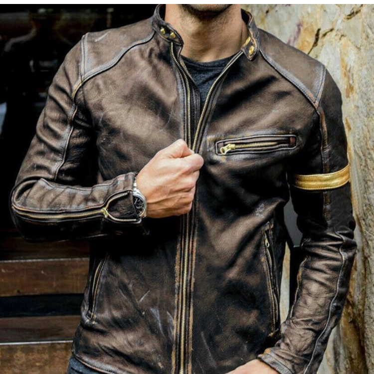 Model wearing a distressed brown leather biker jacket with zippers and a gold armband