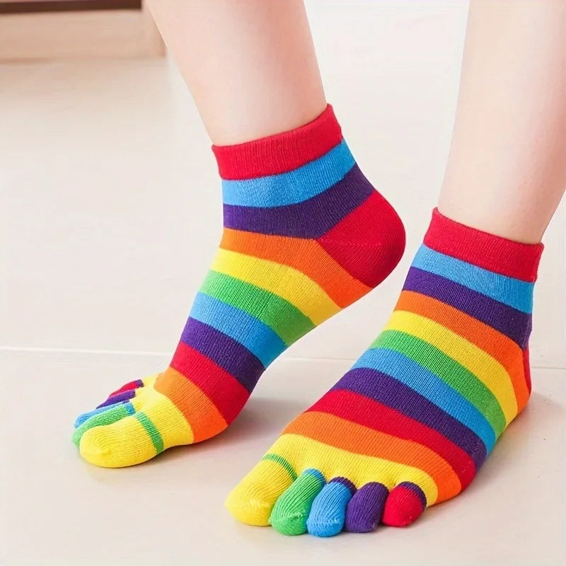 Close-up of rainbow-striped socks with separate colored toe sections on feet
