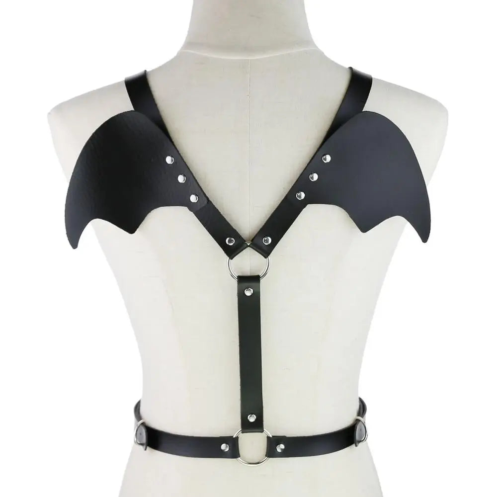 Black bat-wing chest harness with silver rivets, O-rings, and waist strap on a mannequin