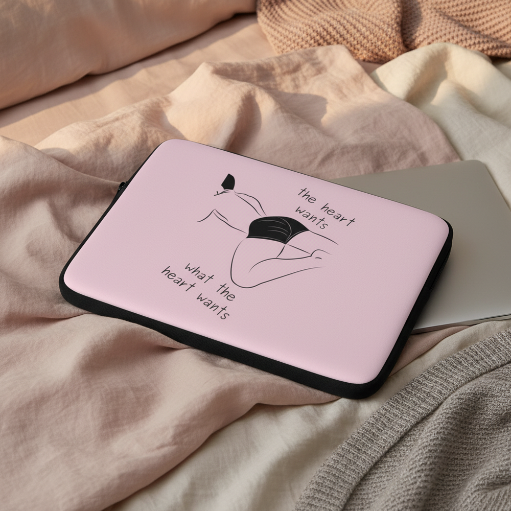 Laptop sleeve in pink neoprene with black trim, featuring a line-art femme figure in black underwear and the heart wants